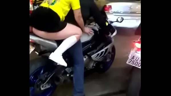 Grote Blonde riding a motorcycle with a short skirt krachtfilms