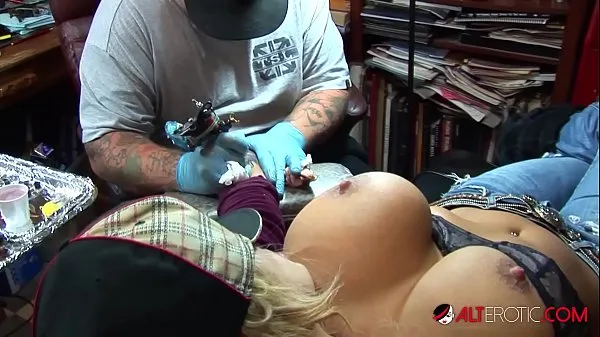 Big Busty blonde pornstar pulls out her huge tits while getting a tattoo on her wrist power Movies